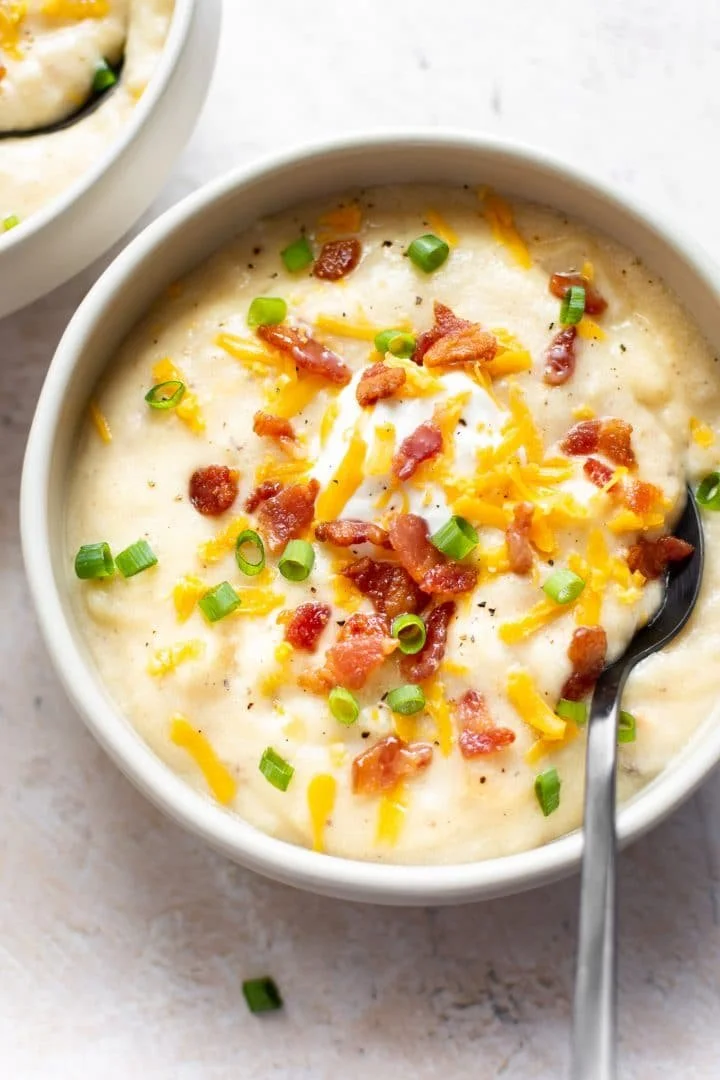 Bowl of easy baked potato soup topped with cheese and chives